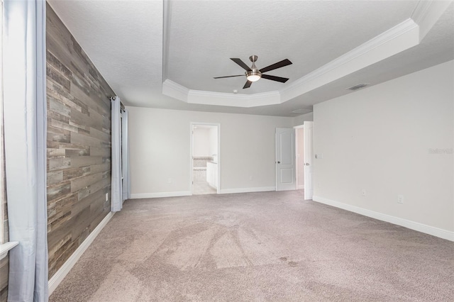 17044 Goldcrest Loop, Clermont, FL 34714 - carpeted spare room featuring a tray ceiling, a ceiling fan, baseboards, crown molding, and a textured ceiling