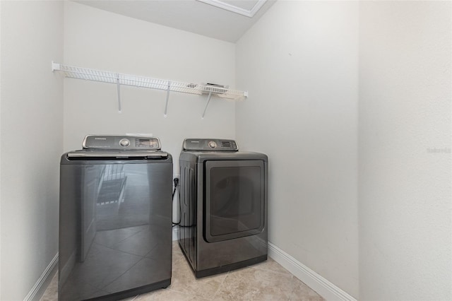 17044 Goldcrest Loop, Clermont, FL 34714 - washroom featuring separate washer and dryer, baseboards, and light tile patterned flooring