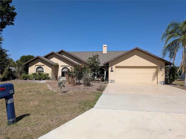 141 Angol St, Punta Gorda, FL 33983 - ranch-style home featuring stucco siding, concrete driveway, a garage, a chimney, and a front yard