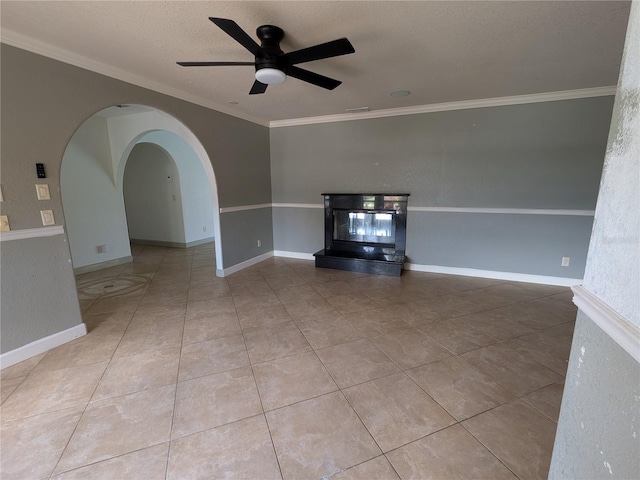 141 Angol St, Punta Gorda, FL 33983 - unfurnished living room with ceiling fan, ornamental molding, arched walkways, tile patterned floors, and a textured ceiling
