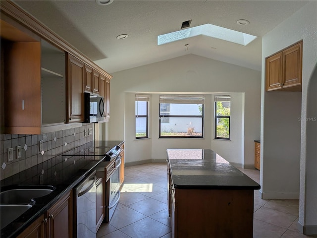 141 Angol St, Punta Gorda, FL 33983 - kitchen with a skylight, stainless steel dishwasher, vaulted ceiling, backsplash, and a center island