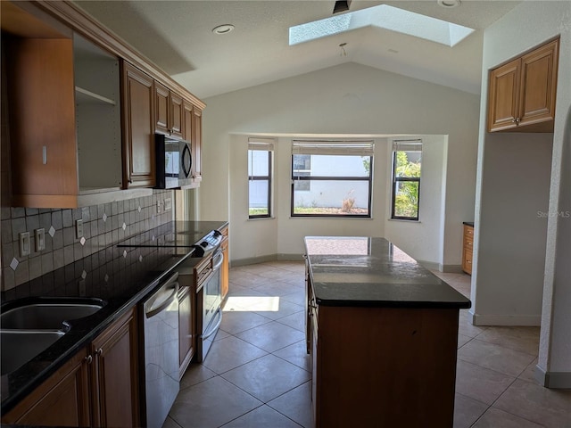 141 Angol St, Punta Gorda, FL 33983 - kitchen featuring a skylight, stainless steel dishwasher, black microwave, a kitchen island, and decorative backsplash
