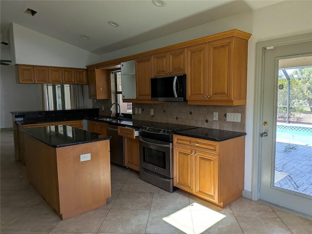 141 Angol St, Punta Gorda, FL 33983 - kitchen featuring stainless steel range with electric cooktop, lofted ceiling, tasteful backsplash, a sink, and a peninsula