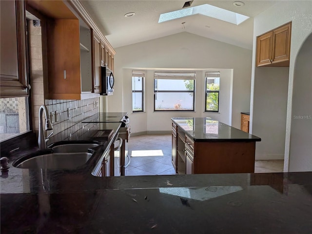 141 Angol St, Punta Gorda, FL 33983 - kitchen featuring a skylight, a sink, vaulted ceiling, tasteful backsplash, and stainless steel electric range