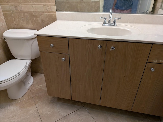 141 Angol St, Punta Gorda, FL 33983 - half bathroom featuring vanity, toilet, tile patterned flooring, and tile walls