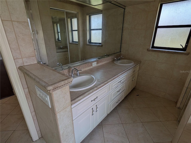 141 Angol St, Punta Gorda, FL 33983 - bathroom featuring tile walls, double vanity, and tile patterned flooring