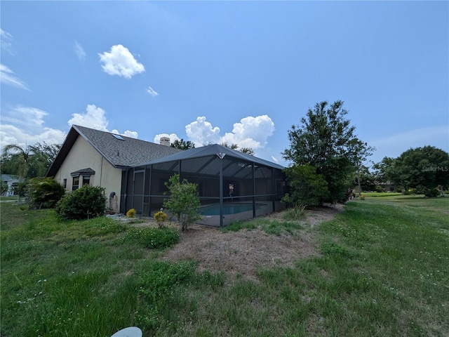 141 Angol St, Punta Gorda, FL 33983 - back of property featuring a lanai, an outdoor pool, stucco siding, a lawn, and a chimney