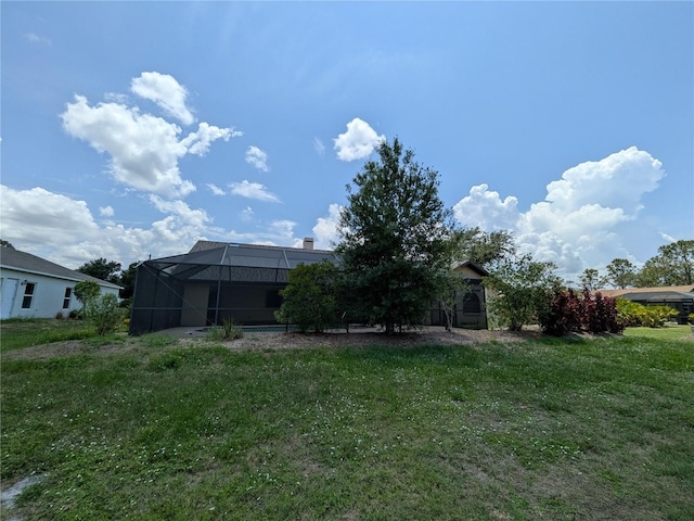 141 Angol St, Punta Gorda, FL 33983 - back of property featuring a lawn and a lanai