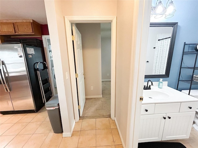 312 W Hull Ave, Oakland, FL 34760 - full bath with vanity, tile patterned floors, and baseboards
