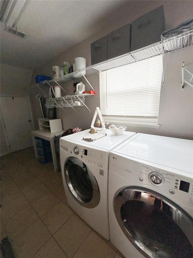 312 W Hull Ave, Oakland, FL 34760 - washroom featuring washing machine and clothes dryer and tile patterned flooring