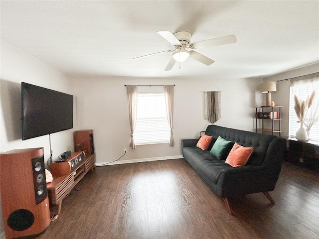 312 W Hull Ave, Oakland, FL 34760 - living area with healthy amount of natural light, wood finished floors, a ceiling fan, and baseboards