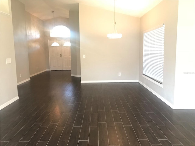 10969 Norcross Cir, Orlando, FL 32825 - empty room featuring vaulted ceiling, dark wood-type flooring, and baseboards