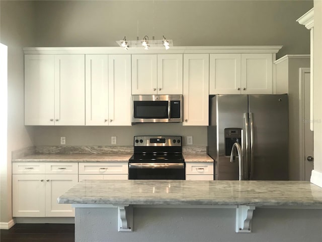 10969 Norcross Cir, Orlando, FL 32825 - kitchen featuring stainless steel appliances, white cabinets, and light stone countertops