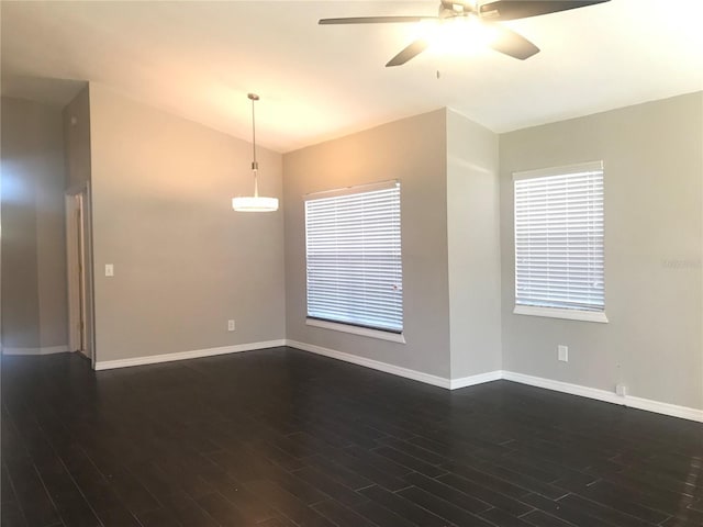 10969 Norcross Cir, Orlando, FL 32825 - spare room with a ceiling fan, dark wood finished floors, baseboards, and vaulted ceiling