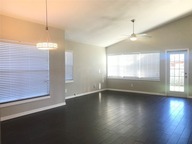 10969 Norcross Cir, Orlando, FL 32825 - unfurnished living room with ceiling fan, healthy amount of natural light, dark wood finished floors, lofted ceiling, and baseboards