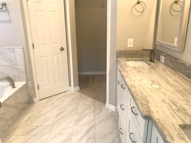 10969 Norcross Cir, Orlando, FL 32825 - bathroom featuring vanity, marble finish floors, a tub, and baseboards