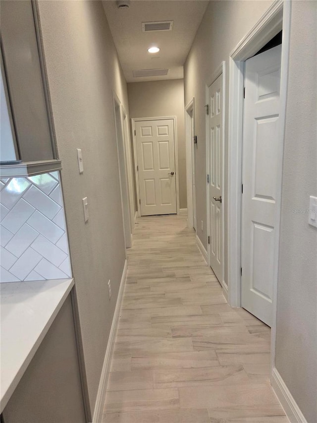 12513 Oak Hill Way, Parrish, FL 34219 - corridor featuring baseboards and light wood finished floors