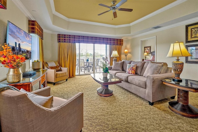 7616 Cabana Ct Unit 301, Reunion, FL 34747 - living area featuring a raised ceiling, carpet, ornamental molding, and a ceiling fan