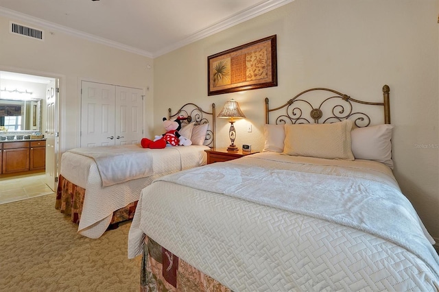7616 Cabana Ct Unit 301, Reunion, FL 34747 - bedroom with crown molding, light colored carpet, a closet, and ensuite bath