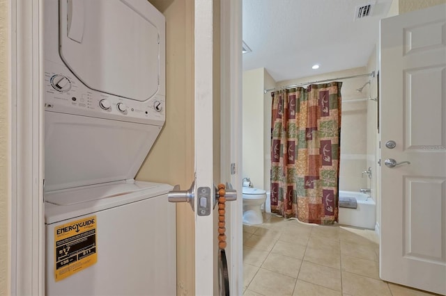 7616 Cabana Ct Unit 301, Reunion, FL 34747 - washroom featuring stacked washer / dryer and light tile patterned floors