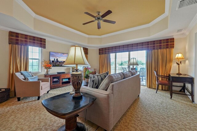 7616 Cabana Ct Unit 301, Reunion, FL 34747 - living room with a tray ceiling, carpet, healthy amount of natural light, and ornamental molding