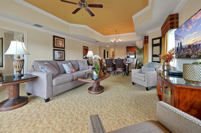 7616 Cabana Ct Unit 301, Reunion, FL 34747 - living room featuring a tray ceiling, carpet floors, a chandelier, ceiling fan, and crown molding