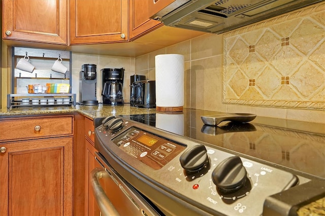 7616 Cabana Ct Unit 301, Reunion, FL 34747 - kitchen featuring electric range, brown cabinets, decorative backsplash, and stone countertops