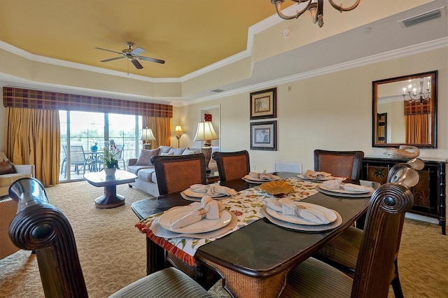 7616 Cabana Ct Unit 301, Reunion, FL 34747 - carpeted dining area featuring a tray ceiling, a chandelier, crown molding, and a ceiling fan