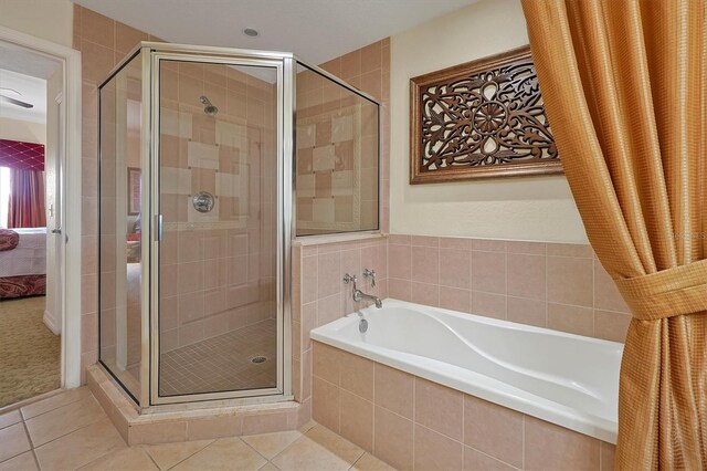 7616 Cabana Ct Unit 301, Reunion, FL 34747 - bathroom with a bath, a shower stall, tile patterned flooring, and ensuite bathroom