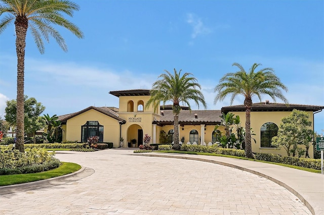 7616 Cabana Ct Unit 301, Reunion, FL 34747 - mediterranean / spanish-style home with curved driveway and stucco siding