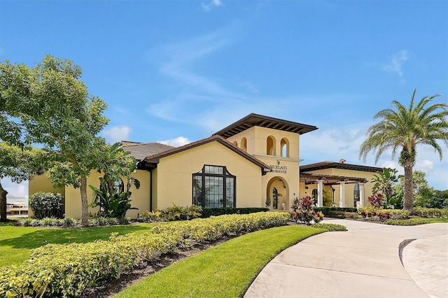 7616 Cabana Ct Unit 301, Reunion, FL 34747 - mediterranean / spanish home featuring stucco siding and a front yard