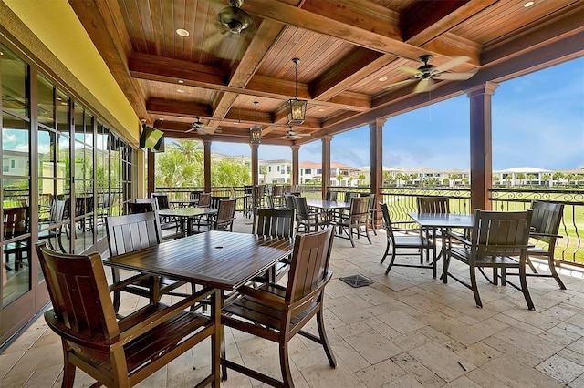 7616 Cabana Ct Unit 301, Reunion, FL 34747 - sunroom with a ceiling fan, outdoor dining area, coffered ceiling, and beam ceiling