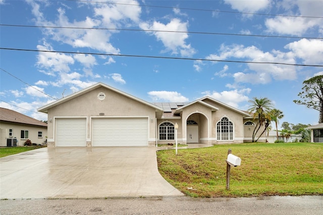 924 Texas St, Englewood, FL 34223 - single story home with stucco siding, roof mounted solar panels, a front lawn, a garage, and concrete driveway