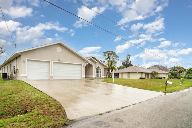 924 Texas St, Englewood, FL 34223 - view of front facade with stucco siding, central AC, a garage, a front lawn, and concrete driveway