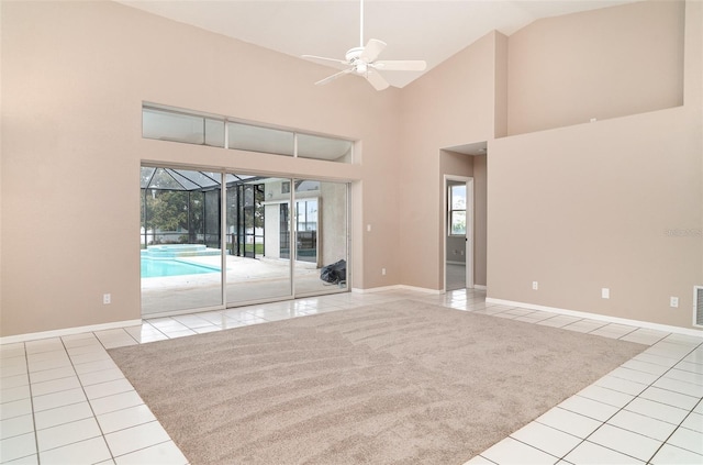 924 Texas St, Englewood, FL 34223 - tiled empty room with a ceiling fan, baseboards, and high vaulted ceiling