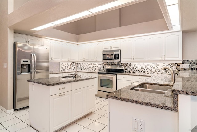 924 Texas St, Englewood, FL 34223 - kitchen with stainless steel appliances, a sink, dark stone counters, and decorative backsplash