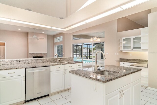 924 Texas St, Englewood, FL 34223 - kitchen with stainless steel dishwasher, a sink, ceiling fan, light tile patterned floors, and high vaulted ceiling