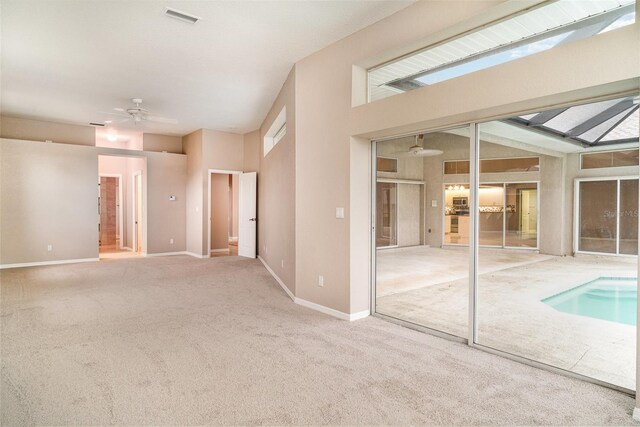 924 Texas St, Englewood, FL 34223 - carpeted empty room featuring ceiling fan, a skylight, and baseboards