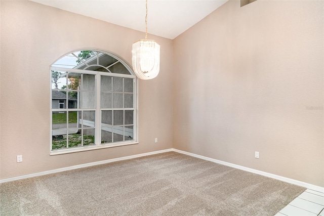 924 Texas St, Englewood, FL 34223 - empty room with a chandelier, baseboards, vaulted ceiling, and carpet floors