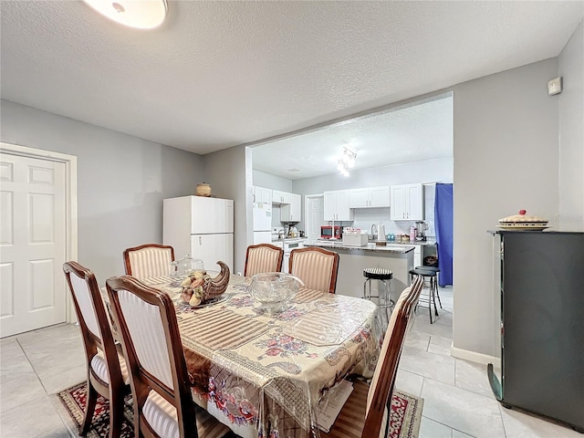 1826 W Silver Springs Blvd, Ocala, FL 34475 - dining room with light tile patterned floors and a textured ceiling