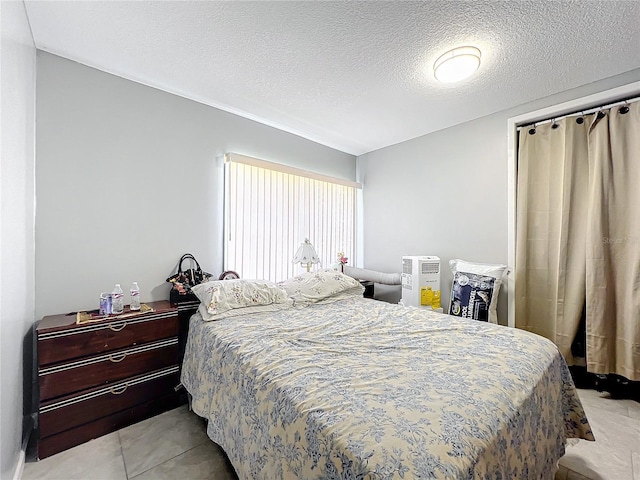1826 W Silver Springs Blvd, Ocala, FL 34475 - bedroom featuring a textured ceiling and light tile patterned floors