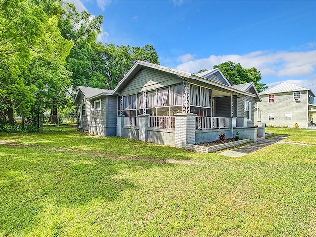 1826 W Silver Springs Blvd, Ocala, FL 34475 - view of side of home featuring a lawn, metal roof, and a sunroom