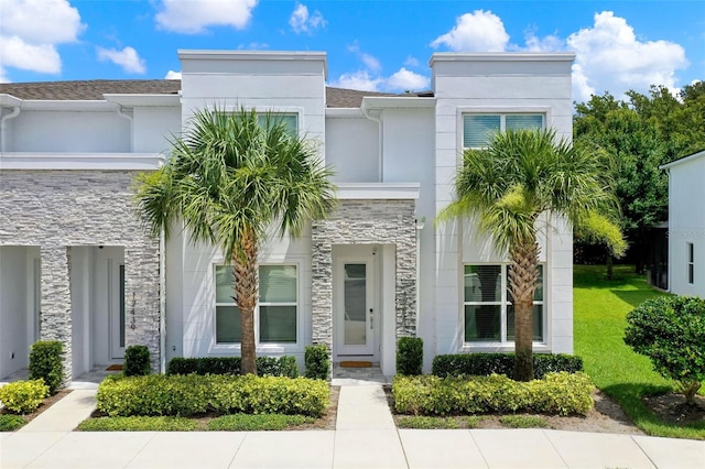 17441 Hidden Forest Dr, Clermont, FL 34714 - contemporary house featuring stone siding and stucco siding