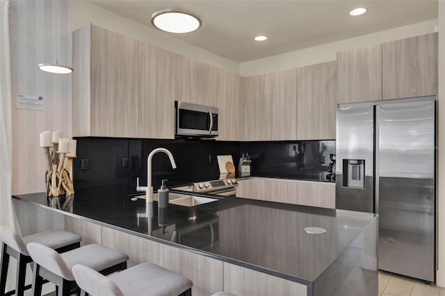 17441 Hidden Forest Dr, Clermont, FL 34714 - kitchen with appliances with stainless steel finishes, light brown cabinets, modern cabinets, a peninsula, and a sink