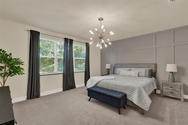 17441 Hidden Forest Dr, Clermont, FL 34714 - bedroom with a chandelier, light colored carpet, a decorative wall, and baseboards
