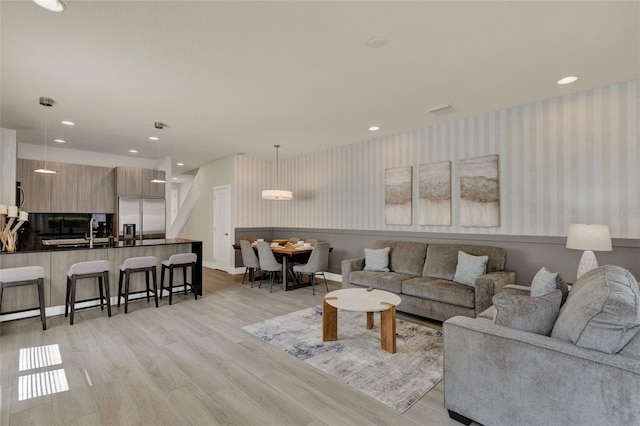 17441 Hidden Forest Dr, Clermont, FL 34714 - living area featuring wallpapered walls, light wood-style flooring, recessed lighting, and baseboards