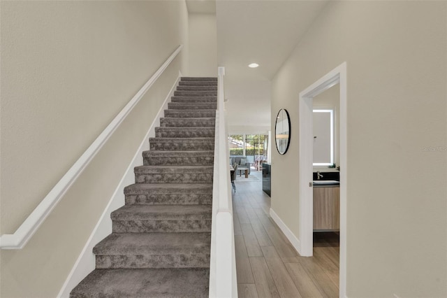 17441 Hidden Forest Dr, Clermont, FL 34714 - stairs featuring wood finished floors, recessed lighting, and baseboards