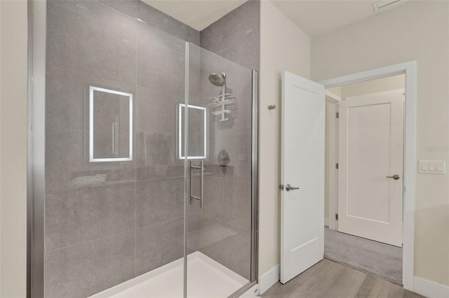 17441 Hidden Forest Dr, Clermont, FL 34714 - bathroom with wood finished floors, a stall shower, and baseboards