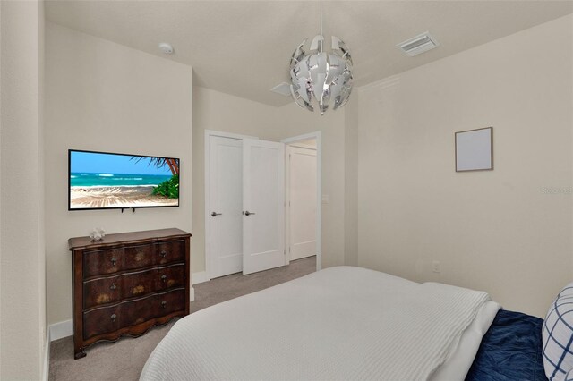 17441 Hidden Forest Dr, Clermont, FL 34714 - bedroom featuring carpet, baseboards, and a chandelier