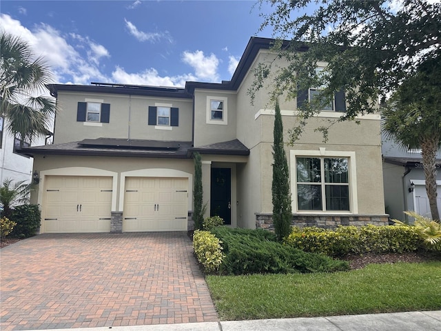 14117 Larkspur Lake Dr, Winter Garden, FL 34787 - townhome / multi-family property with stucco siding, decorative driveway, an attached garage, and stone siding
